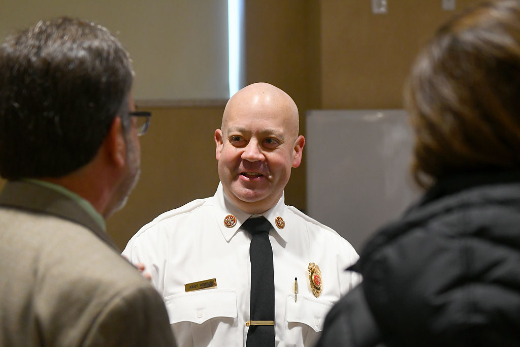 Fire Chief Woody talks to Rebecca Thompson and Robert Rinck from the City Prosecutors Office